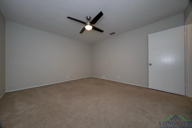 carpeted spare room with ceiling fan