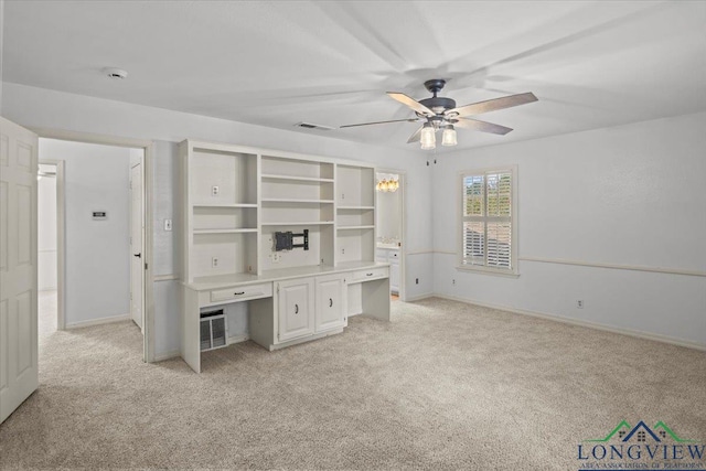 unfurnished office featuring light colored carpet and ceiling fan