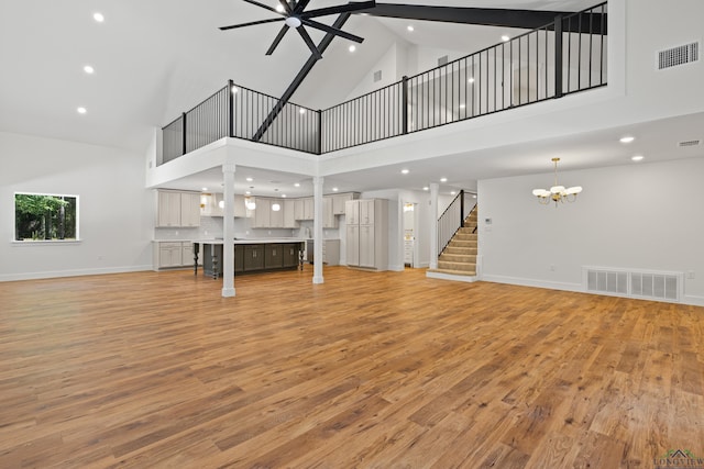330 Forest Hls, Hallsville, TX 75650 - unfurnished living room featuring a chandelier, high vaulted ceiling, recessed lighting, light wood-style flooring, and stairway
