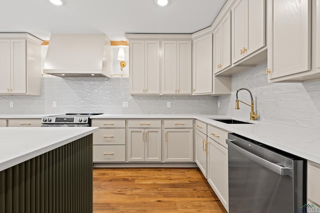 330 Forest Hls, Hallsville, TX 75650 - kitchen with stainless steel appliances, custom range hood, decorative backsplash, light wood-style floors, and recessed lighting