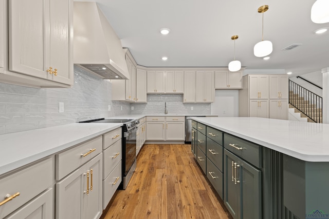 330 Forest Hls, Hallsville, TX 75650 - kitchen featuring premium range hood, range with electric cooktop, pendant lighting, light wood-style floors, and white cabinets