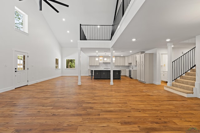 330 Forest Hls, Hallsville, TX 75650 - unfurnished living room with high vaulted ceiling, healthy amount of natural light, light wood finished floors, a ceiling fan, and recessed lighting