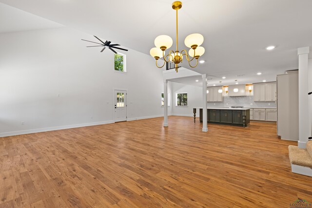 330 Forest Hls, Hallsville, TX 75650 - unfurnished living room with recessed lighting, light wood finished floors, a chandelier, and high vaulted ceiling