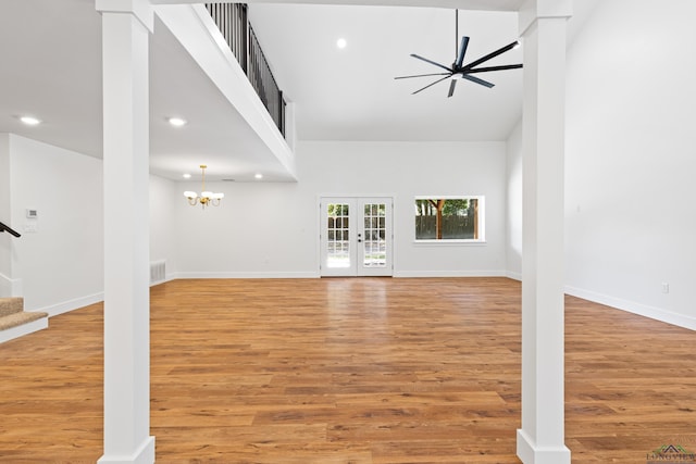 330 Forest Hls, Hallsville, TX 75650 - unfurnished living room with stairs, recessed lighting, light wood-type flooring, a towering ceiling, and a chandelier