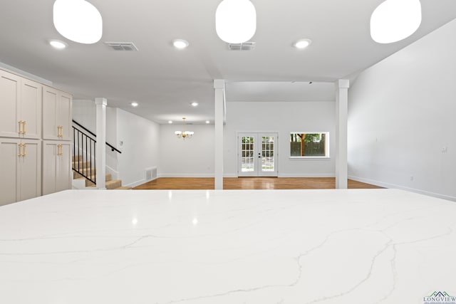 330 Forest Hls, Hallsville, TX 75650 - unfurnished living room with stairway, recessed lighting, light wood-style floors, ornate columns, and french doors