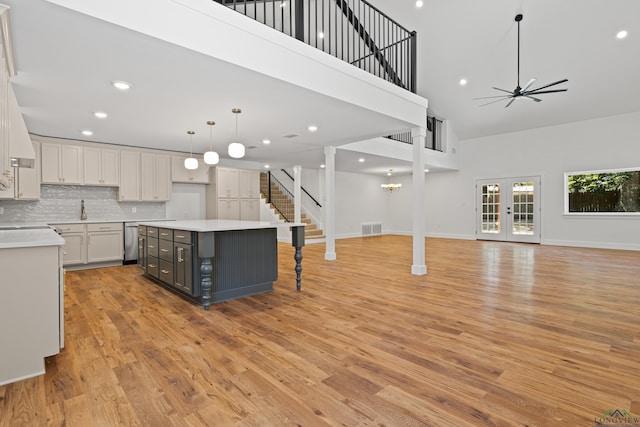 330 Forest Hls, Hallsville, TX 75650 - kitchen with a towering ceiling, open floor plan, light wood finished floors, light countertops, and gray cabinetry