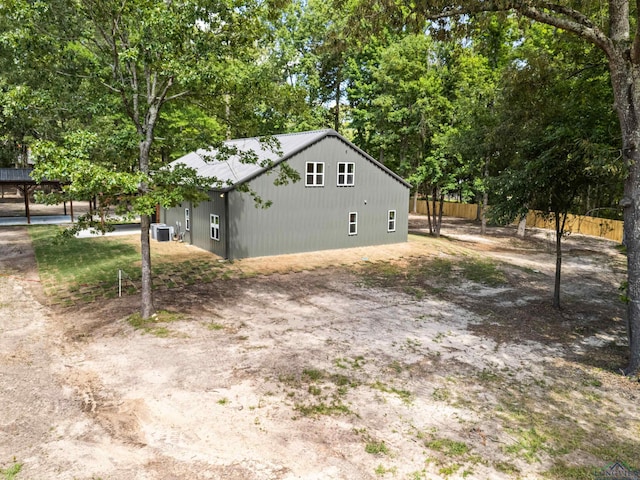 330 Forest Hls, Hallsville, TX 75650 - view of side of property with a central air condition unit and view of scattered trees