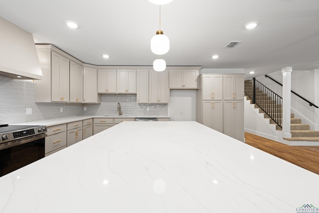330 Forest Hls, Hallsville, TX 75650 - kitchen featuring premium range hood, electric stove, backsplash, pendant lighting, and gray cabinetry