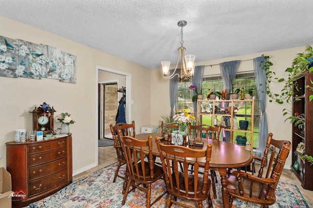 dining space featuring a textured ceiling and an inviting chandelier