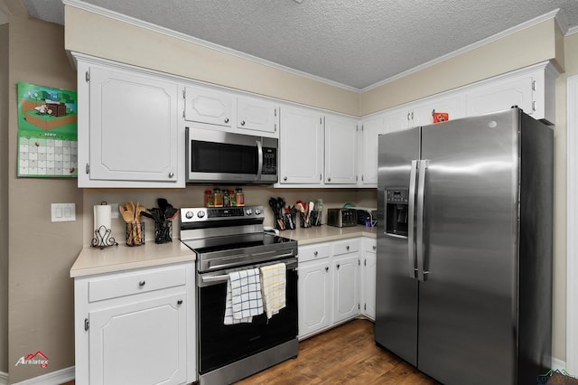 kitchen with appliances with stainless steel finishes, a textured ceiling, crown molding, white cabinets, and dark hardwood / wood-style floors