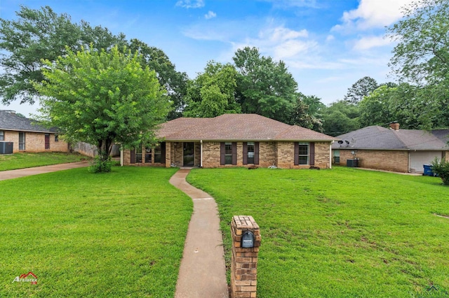 single story home featuring cooling unit and a front lawn