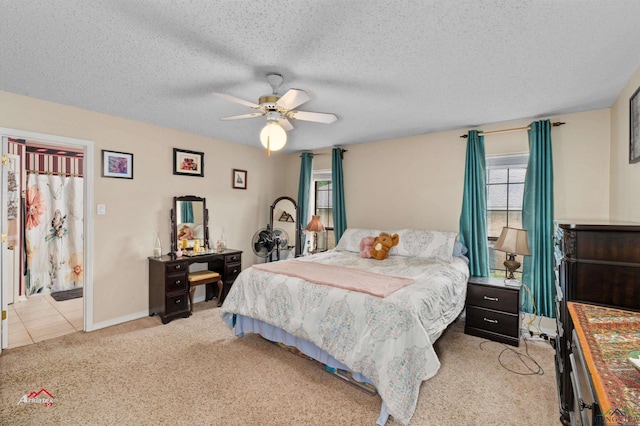 bedroom with a textured ceiling, light colored carpet, and ceiling fan