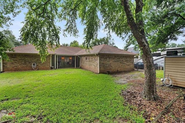 back of property with a lawn