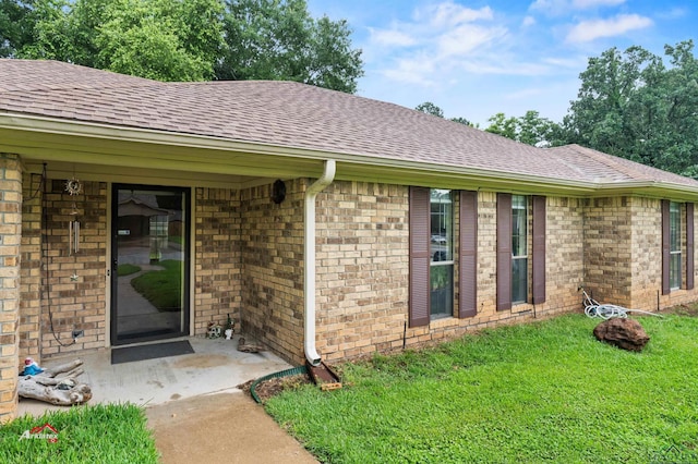 doorway to property with a yard