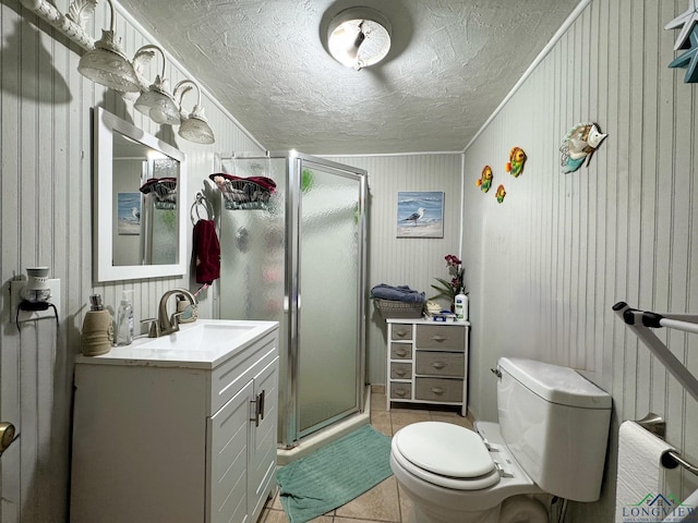 bathroom featuring tile patterned floors, an enclosed shower, vanity, and a textured ceiling