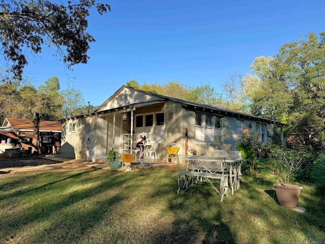 back of house with a yard