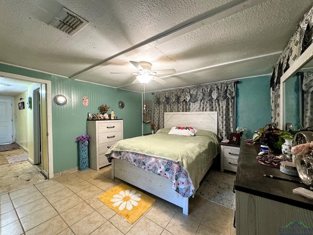 tiled bedroom featuring a textured ceiling and ceiling fan