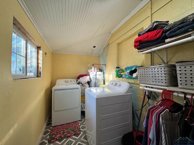 clothes washing area with washer and clothes dryer and wooden ceiling