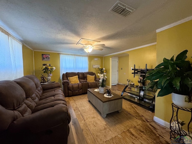 living room featuring crown molding, a textured ceiling, ceiling fan, and light hardwood / wood-style flooring