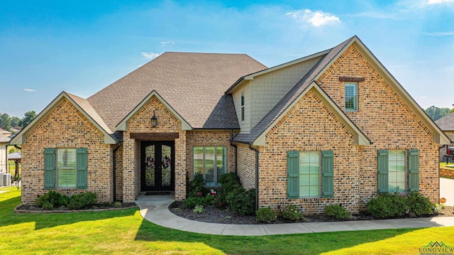 2901 Fairway Oaks Ln, Longview, TX 75605 - view of front of house with brick siding, a front lawn, french doors, and roof with shingles