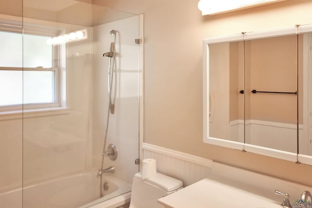 full bathroom with a wainscoted wall, shower / tub combination, vanity, and toilet