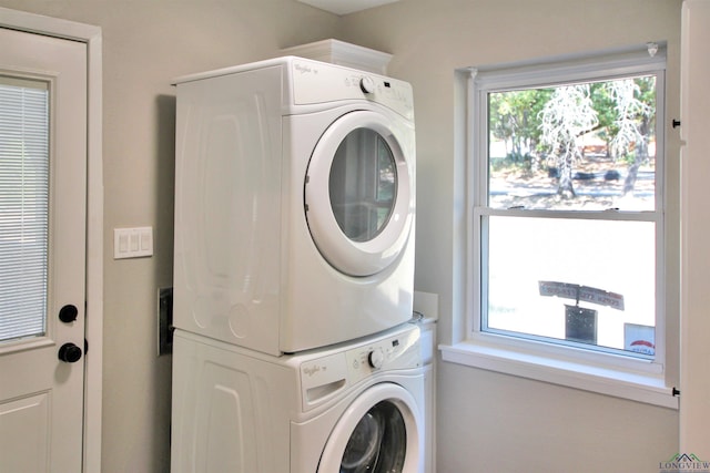 laundry room featuring stacked washer / dryer and laundry area