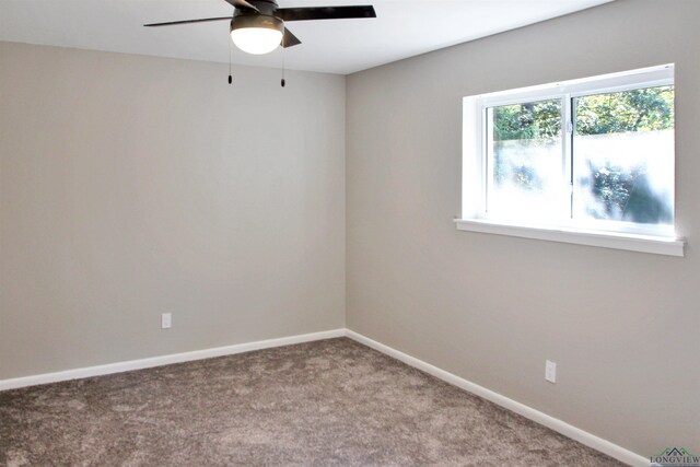 unfurnished room featuring carpet floors, baseboards, and a ceiling fan