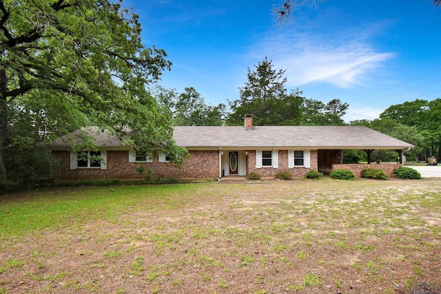 ranch-style home with a chimney, a front lawn, and brick siding