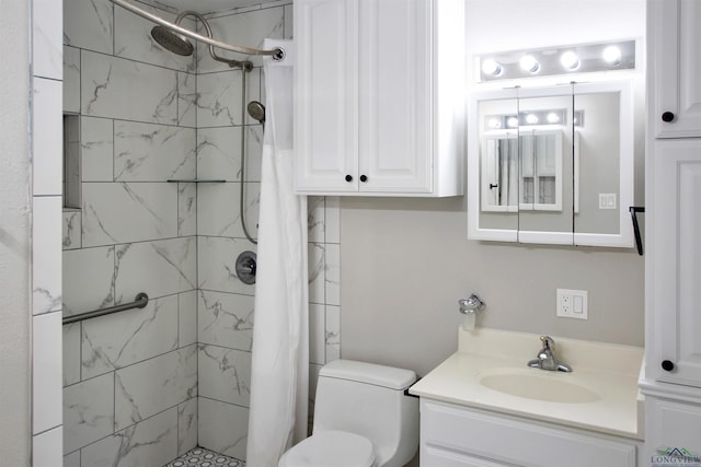 bathroom with toilet, a stall shower, and vanity