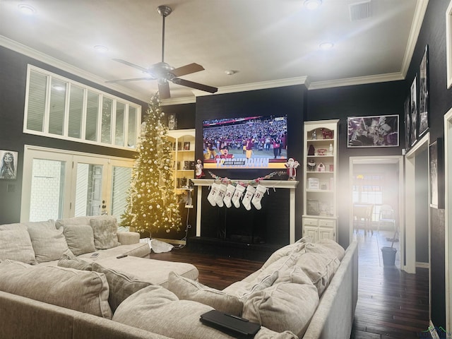 living room with ceiling fan, ornamental molding, and dark wood-type flooring