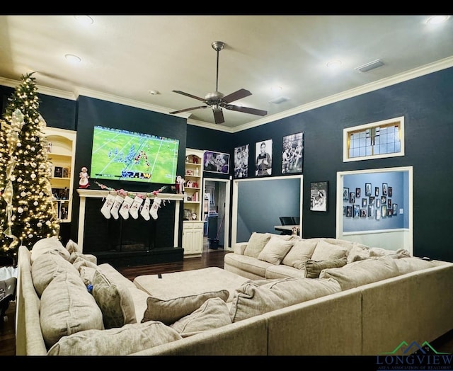 cinema with crown molding, hardwood / wood-style floors, and ceiling fan