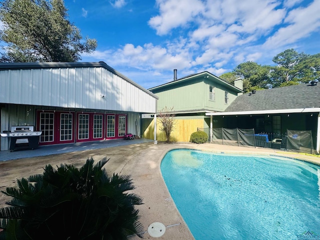 view of pool with a grill and a patio area