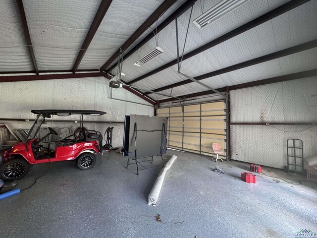 garage featuring a garage door opener and a carport