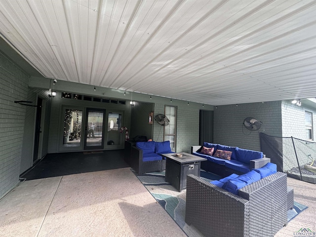 view of patio / terrace with an outdoor living space with a fire pit