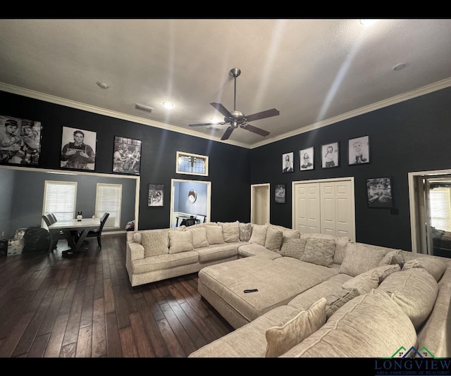 cinema featuring ceiling fan, dark hardwood / wood-style floors, and ornamental molding