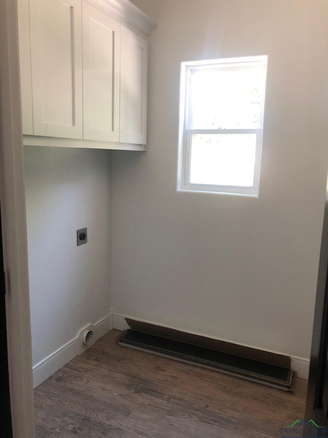 clothes washing area featuring electric dryer hookup and dark hardwood / wood-style floors