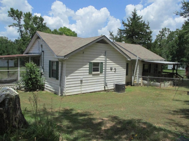 view of home's exterior with central air condition unit and a lawn