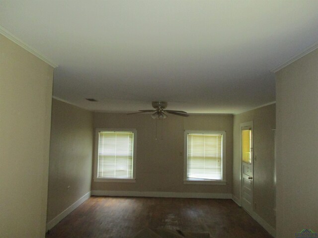 spare room with dark hardwood / wood-style floors, a healthy amount of sunlight, crown molding, and ceiling fan