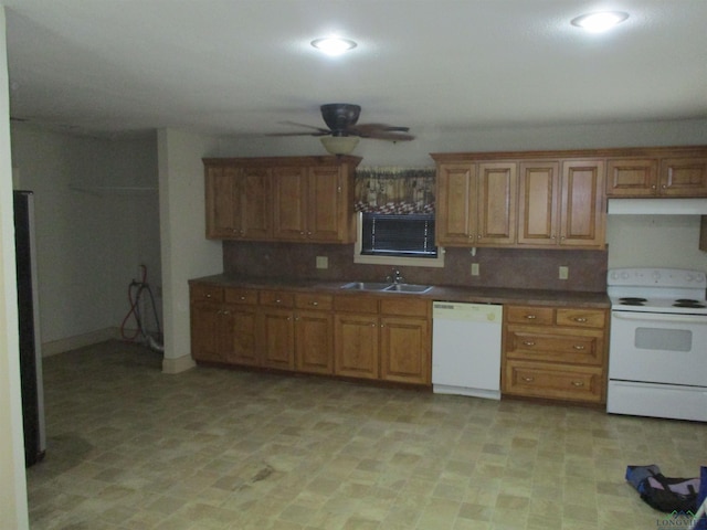 kitchen with decorative backsplash, white appliances, and sink