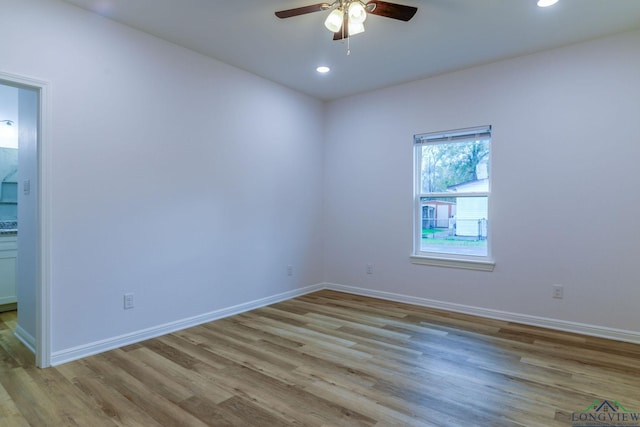 spare room with light hardwood / wood-style flooring and ceiling fan