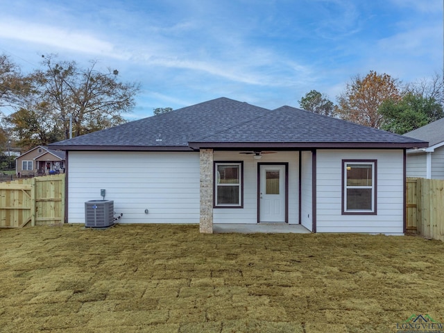 back of house featuring ceiling fan, cooling unit, and a lawn