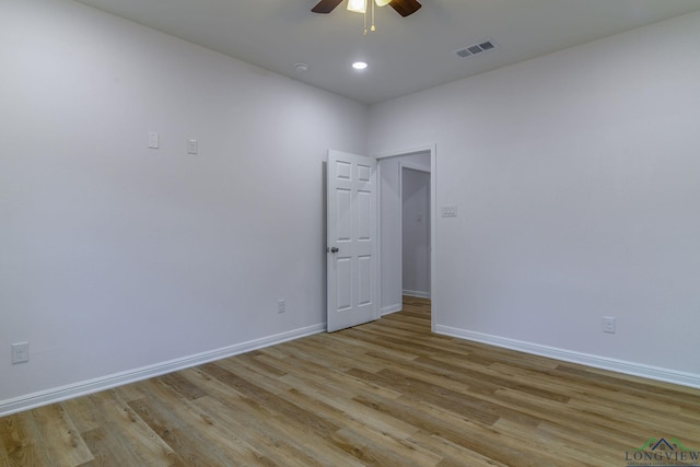 spare room with light wood-type flooring and ceiling fan