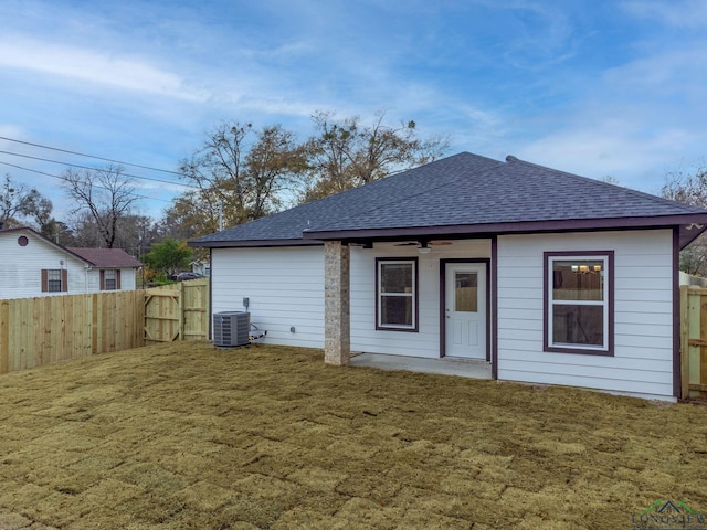 back of house with a yard, cooling unit, and ceiling fan