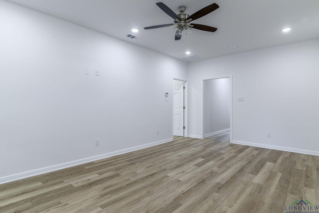 spare room with ceiling fan and light hardwood / wood-style flooring