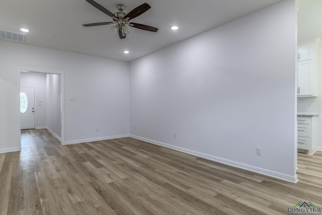 unfurnished room featuring ceiling fan and light wood-type flooring