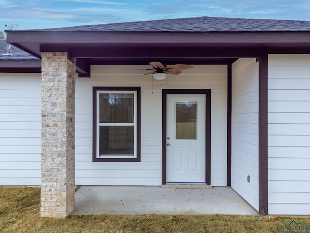 entrance to property featuring ceiling fan