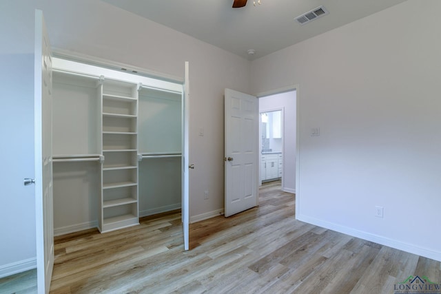 unfurnished bedroom featuring light wood-type flooring, a closet, and ceiling fan