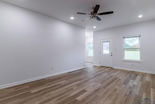 foyer entrance with a healthy amount of sunlight, ceiling fan, and light hardwood / wood-style floors