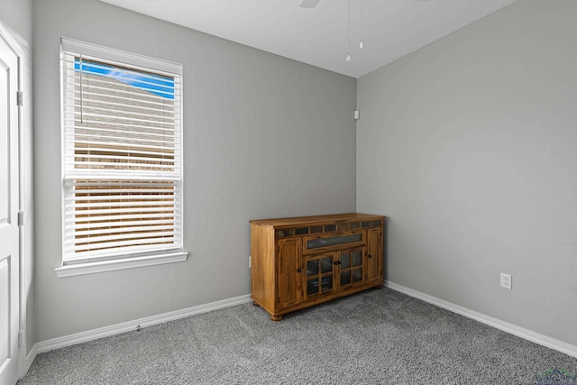 unfurnished room with ceiling fan and light carpet