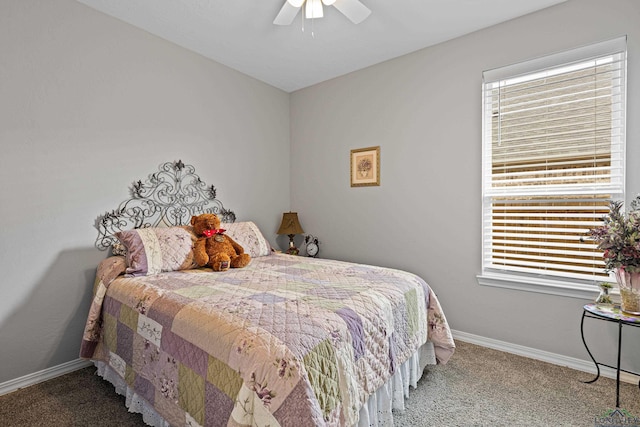 bedroom with multiple windows, ceiling fan, and carpet floors